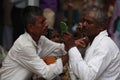 Pune, India - Ã¢â¬Å½July 11, Ã¢â¬Å½2015:A streetside barber shaves a Royalty Free Stock Photo